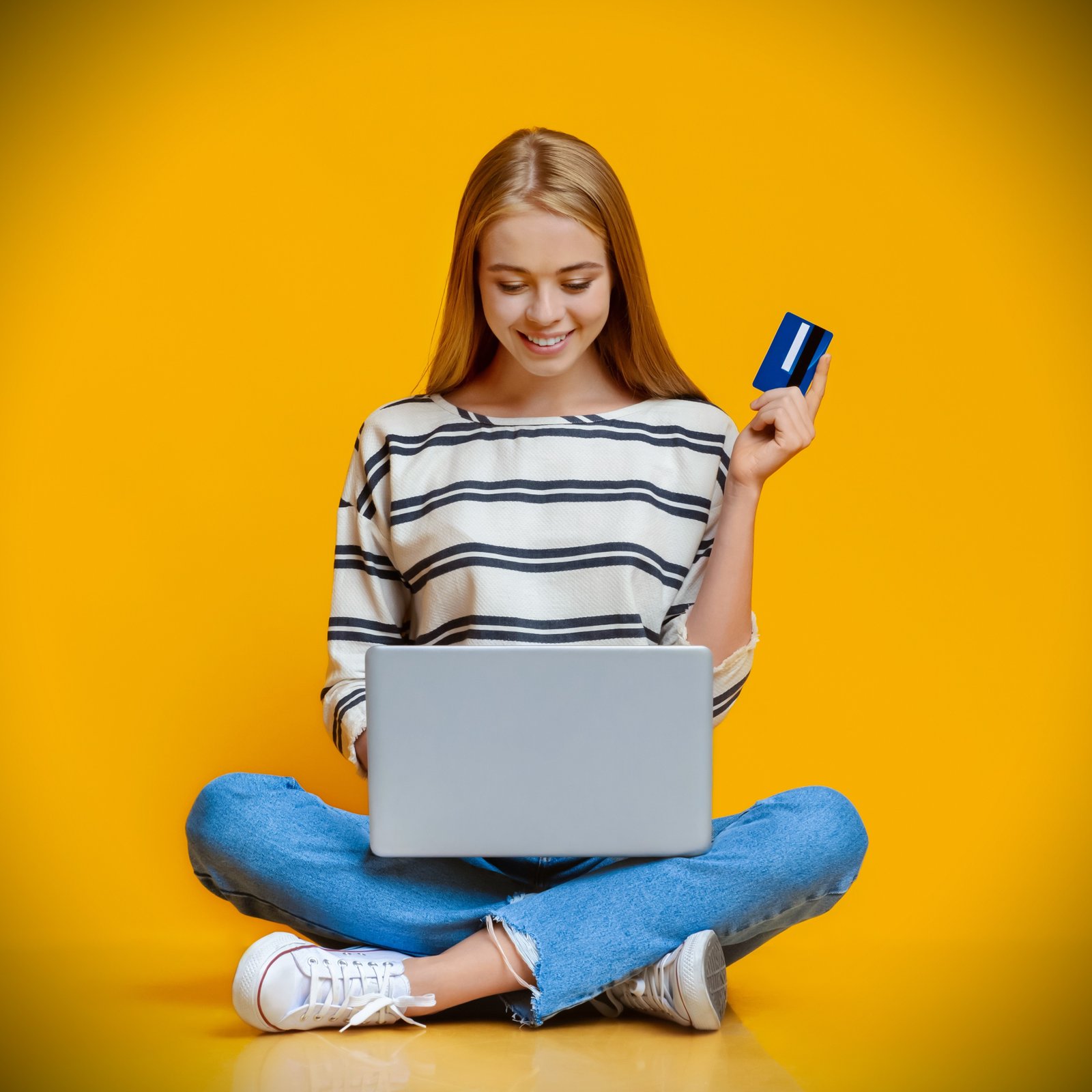 teen-girl-sitting-on-floor-with-laptop-and-credit-2025-03-18-17-22-47-utc