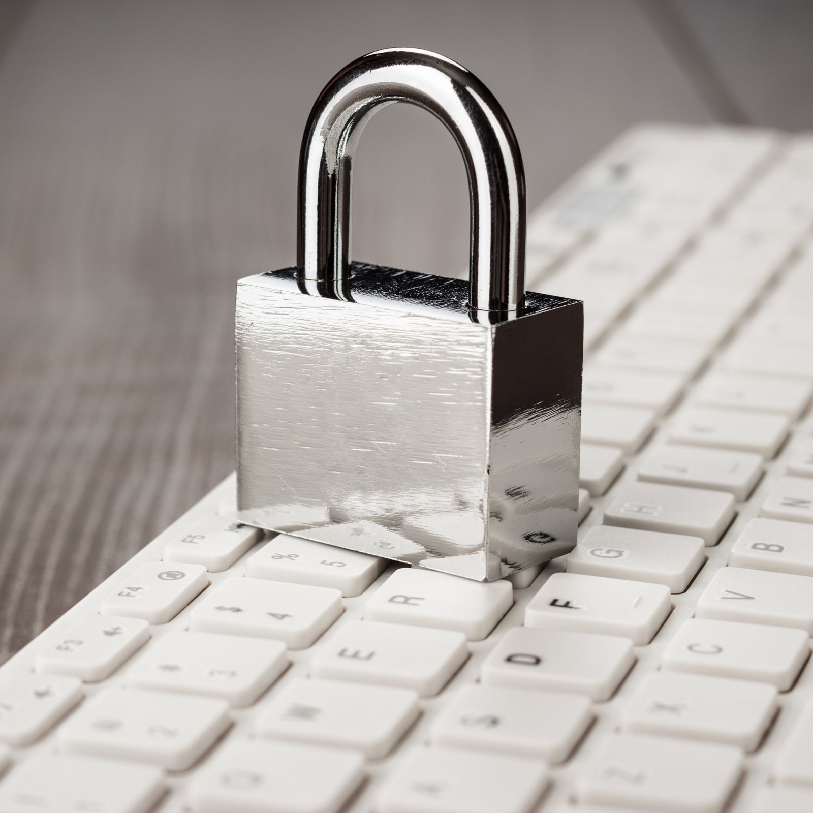 padlock-and-white-computer-keyboard-on-the-wooden-2025-01-08-09-07-38-utc