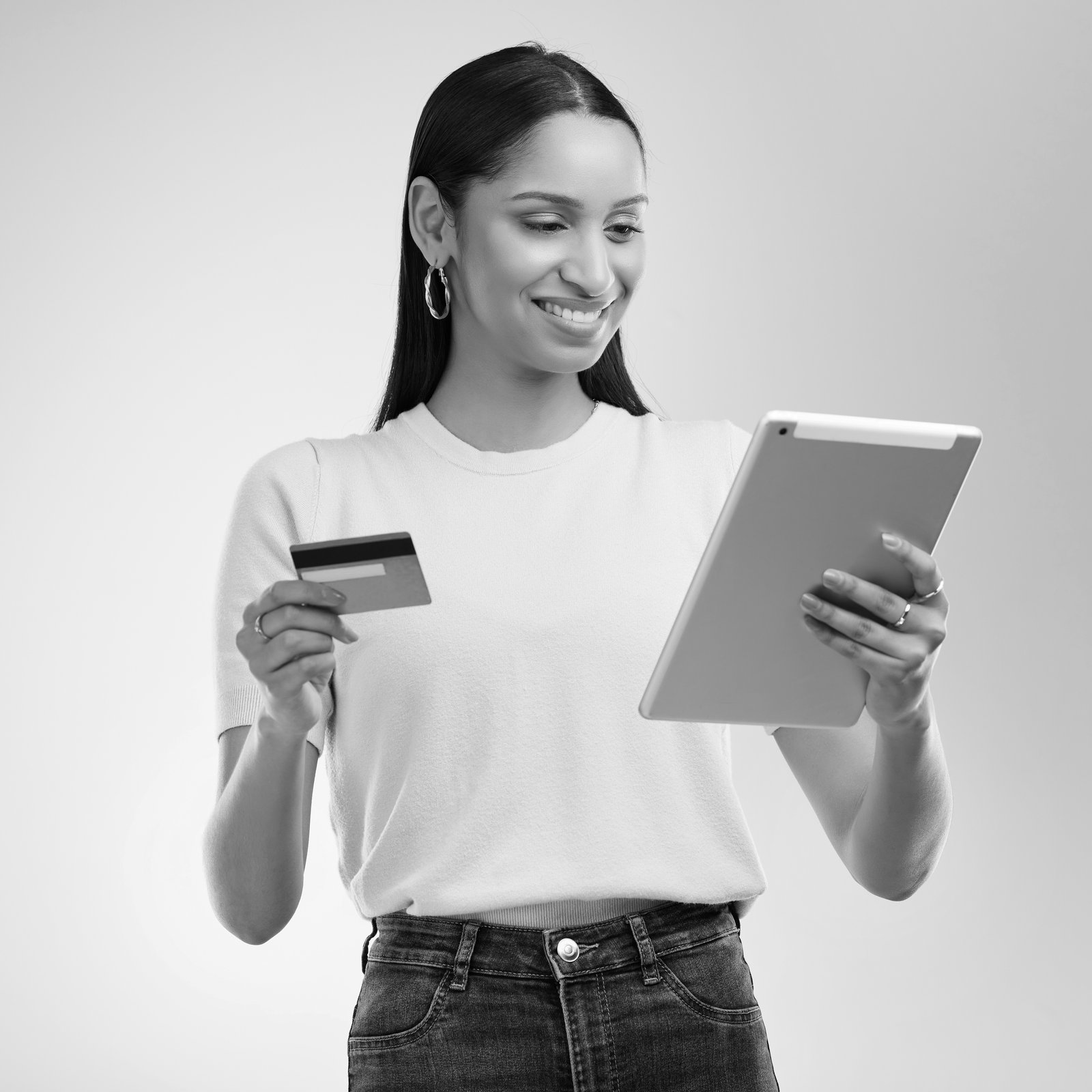 shot-of-a-woman-holding-a-bank-card-and-using-a-di-2025-04-06-11-50-51-utc